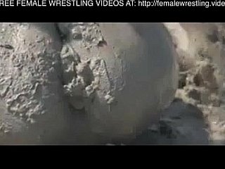 Girls wrestling thither the mud
